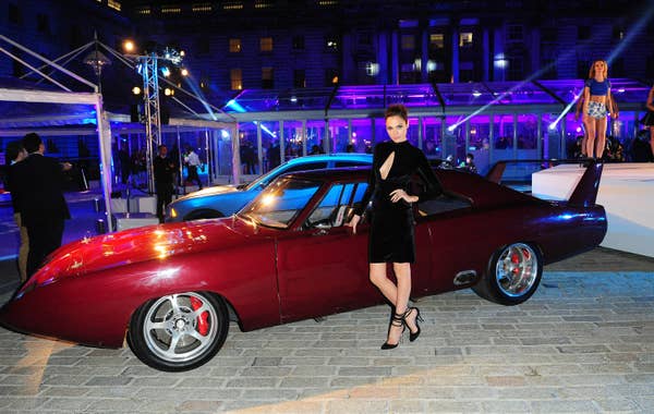 Gal Gadot posing by a red car for Fast     Furious